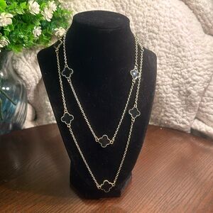 Long gold-tone long necklace with black clovers